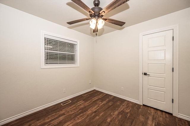 empty room featuring ceiling fan and dark hardwood / wood-style flooring