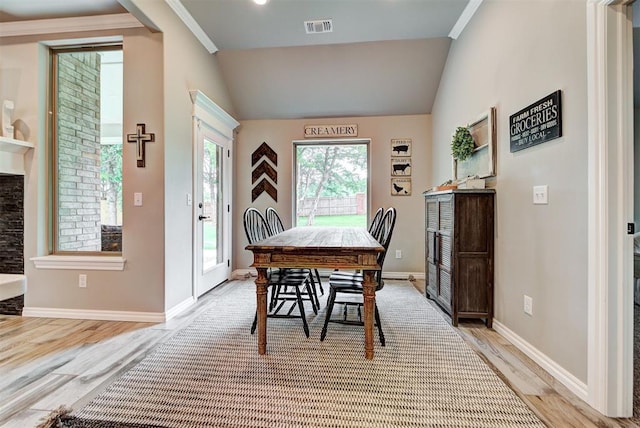 dining area featuring light hardwood / wood-style floors and lofted ceiling