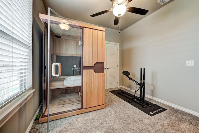 workout area featuring carpet and ceiling fan