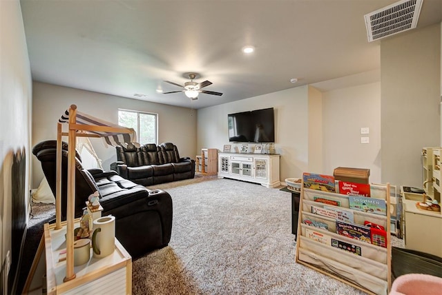 living room with ceiling fan and carpet