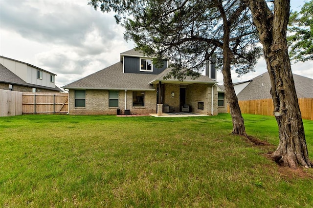 rear view of house with a patio area and a yard