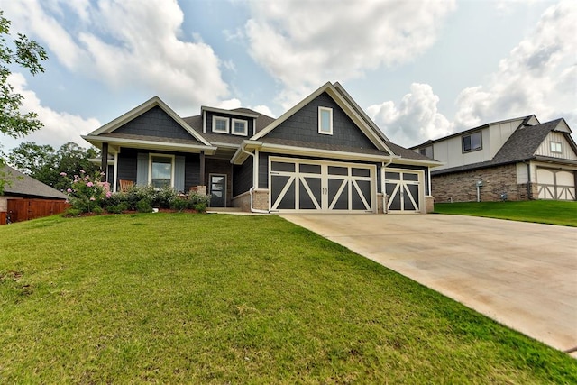 craftsman-style house featuring a front yard and a garage