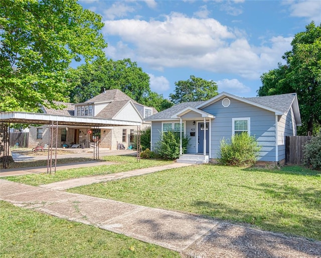 view of front of home with a carport and a front lawn