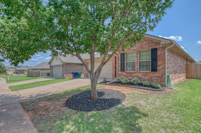 view of front of home with a front yard and a garage