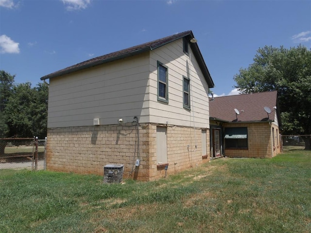 view of side of property with a lawn