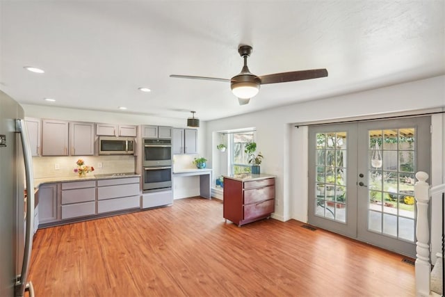 kitchen featuring french doors, decorative backsplash, gray cabinets, ceiling fan, and stainless steel appliances