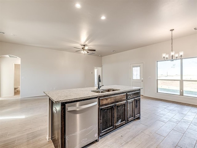 kitchen featuring ceiling fan with notable chandelier, sink, a center island with sink, dishwasher, and hanging light fixtures