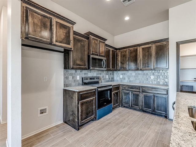 kitchen featuring decorative backsplash, light stone countertops, dark brown cabinets, electric range, and light hardwood / wood-style floors