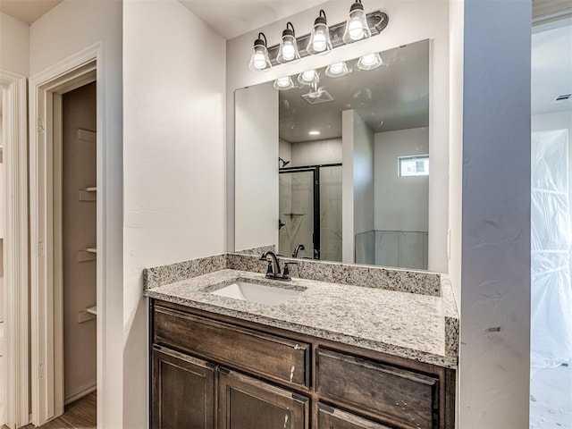 bathroom with vanity and walk in shower