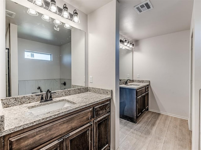 bathroom with hardwood / wood-style floors and vanity