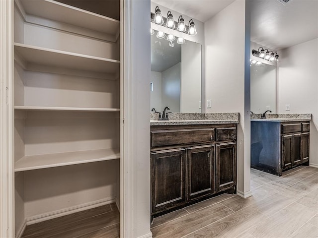 bathroom with hardwood / wood-style floors and vanity