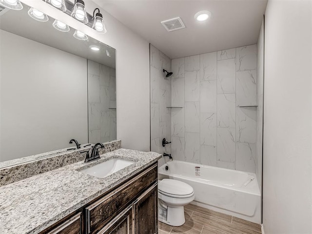 full bathroom with vanity, toilet, and tiled shower / bath