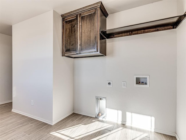 clothes washing area featuring electric dryer hookup, cabinets, hookup for a washing machine, and light hardwood / wood-style floors