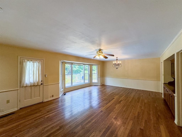 unfurnished living room featuring ceiling fan with notable chandelier and dark hardwood / wood-style flooring