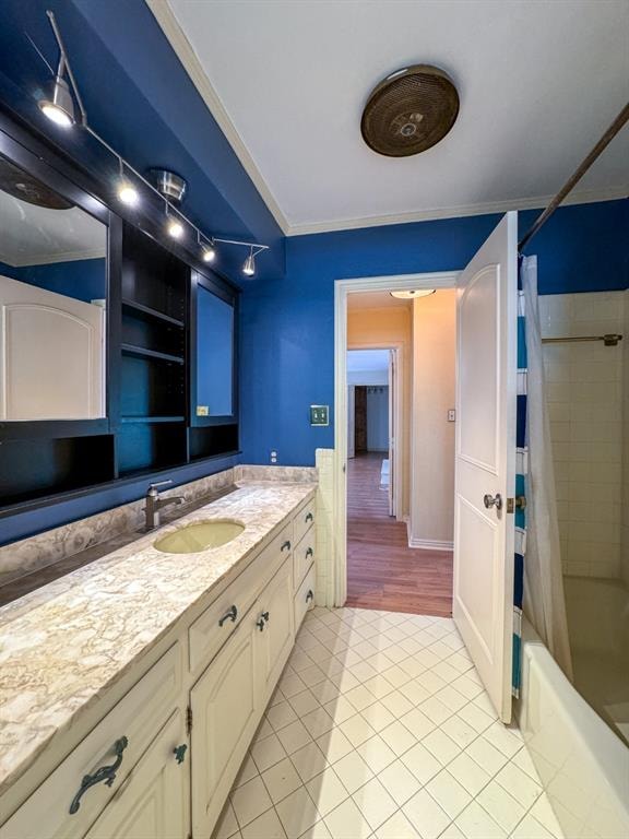 bathroom featuring shower / bath combination with curtain, vanity, tile patterned floors, and crown molding