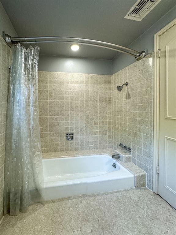 bathroom with tile patterned flooring and shower / bathtub combination with curtain