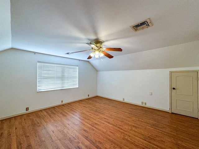 additional living space featuring ceiling fan, wood-type flooring, and vaulted ceiling