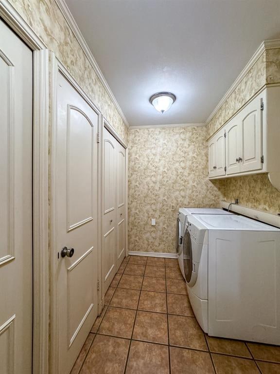 washroom featuring tile patterned floors, separate washer and dryer, crown molding, and cabinets