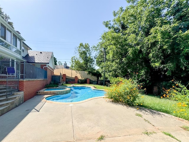 view of pool with an in ground hot tub and a patio area