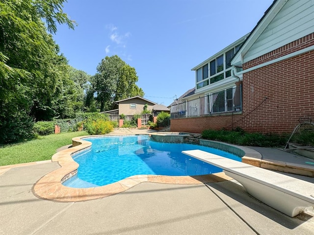 view of pool featuring a diving board and a patio area