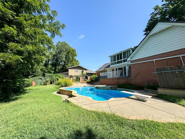 view of swimming pool with a lawn, a diving board, a patio area, and an in ground hot tub