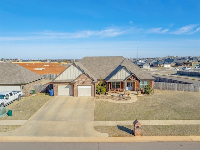 craftsman-style home featuring concrete driveway, brick siding, fence, and a residential view