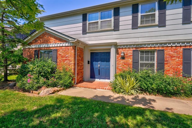 doorway to property featuring a lawn