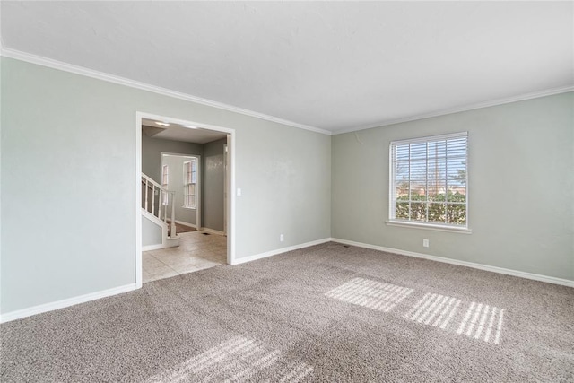 carpeted spare room featuring crown molding