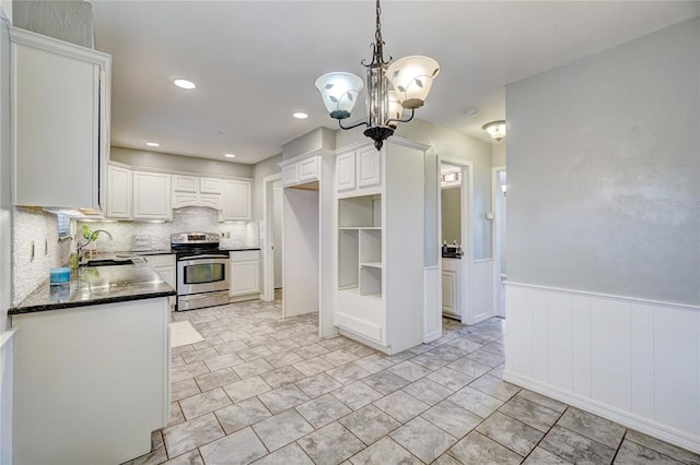 kitchen with decorative backsplash, white cabinetry, sink, and stainless steel range with electric stovetop