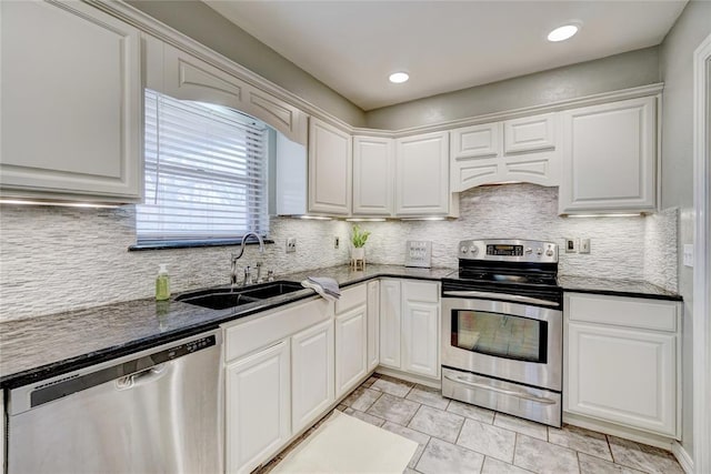 kitchen with backsplash, white cabinetry, sink, and stainless steel appliances