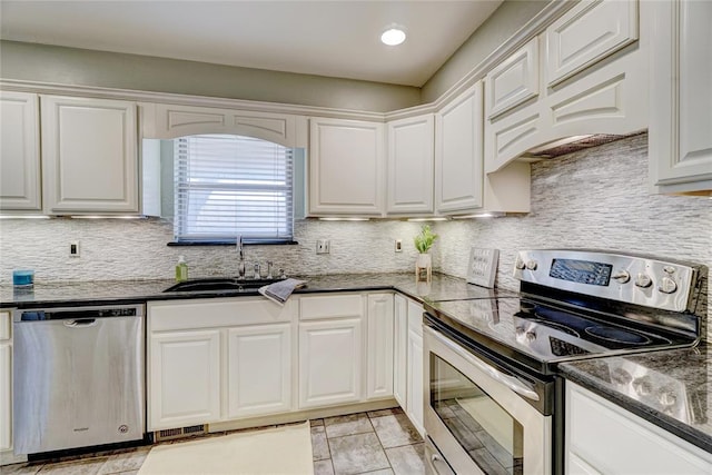 kitchen with white cabinetry, sink, stainless steel appliances, backsplash, and custom range hood