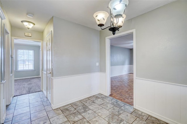 spare room featuring a notable chandelier