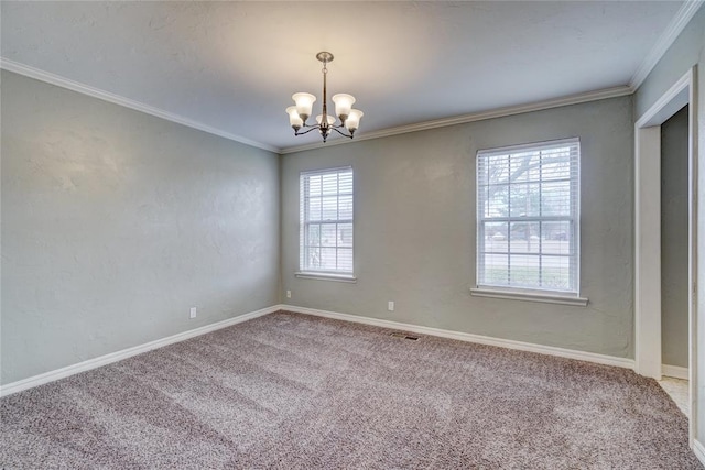 carpeted spare room with ornamental molding and an inviting chandelier