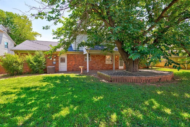 exterior space featuring a lawn and central AC