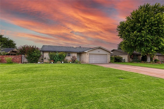 view of front of home featuring a garage and a lawn