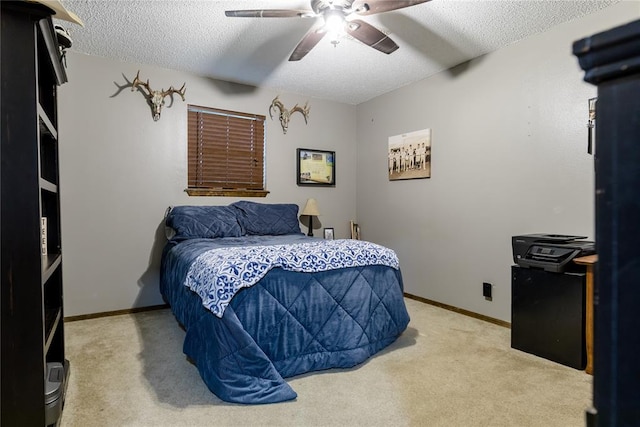 bedroom with carpet flooring, ceiling fan, and a textured ceiling