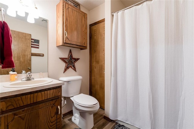 bathroom featuring hardwood / wood-style floors, vanity, and toilet