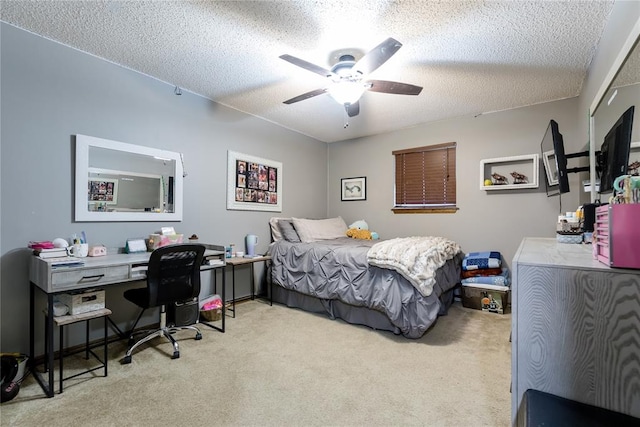 carpeted bedroom with ceiling fan and a textured ceiling