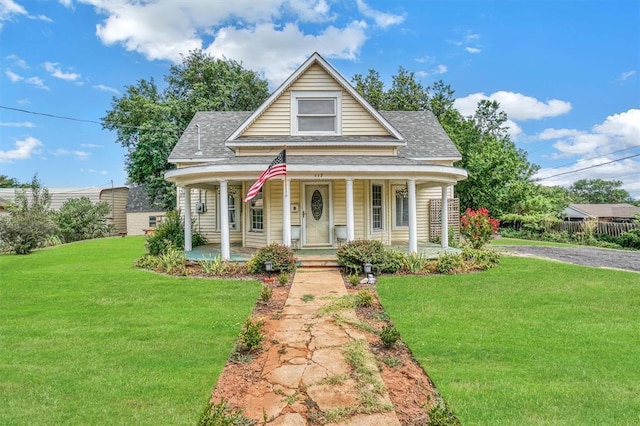 117 W 6th St, Cordell, OK 73632 - bungalow-style house featuring a shingled roof, a front lawn, and covered porch