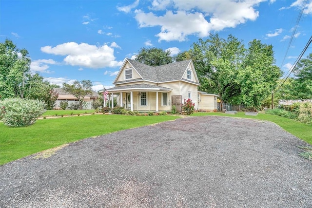 117 W 6th St, Cordell, OK 73632 - view of front of house with a porch, a front yard, a shingled roof, and driveway