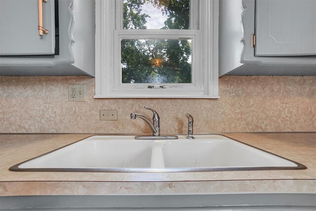 117 W 6th St, Cordell, OK 73632 - kitchen with a sink, light countertops, and backsplash