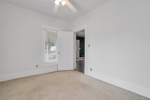 117 W 6th St, Cordell, OK 73632 - empty room featuring light colored carpet, a ceiling fan, and baseboards
