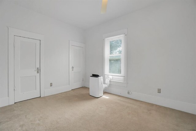 117 W 6th St, Cordell, OK 73632 - unfurnished bedroom featuring carpet floors, baseboards, and ceiling fan