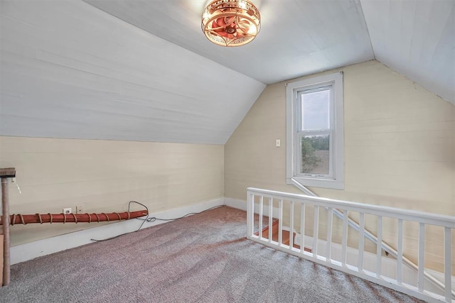 bonus room with carpet flooring and vaulted ceiling