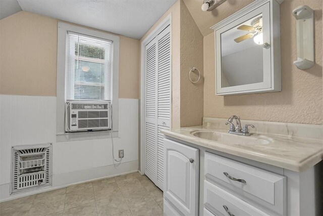 117 W 6th St, Cordell, OK 73632 - bathroom featuring vanity, heating unit, a textured wall, cooling unit, and a closet