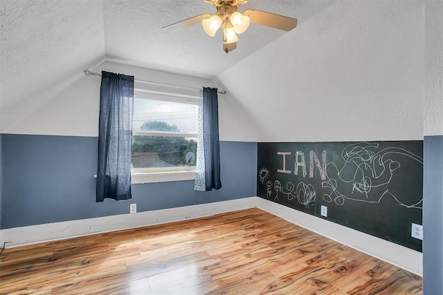 117 W 6th St, Cordell, OK 73632 - additional living space with a textured ceiling, lofted ceiling, ceiling fan, wood finished floors, and baseboards