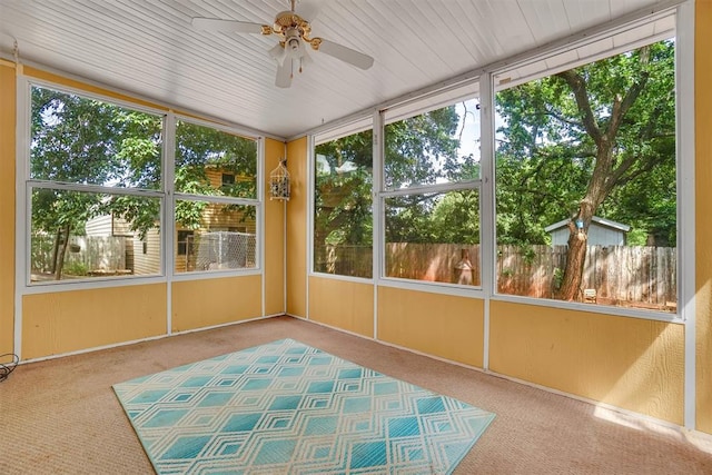 unfurnished sunroom with ceiling fan and a healthy amount of sunlight