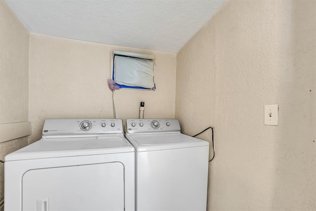 117 W 6th St, Cordell, OK 73632 - laundry room with washer and clothes dryer, a textured ceiling, and a textured wall