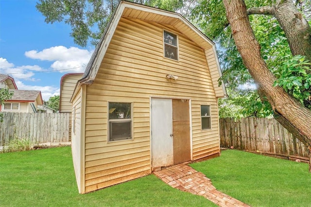 view of outbuilding featuring a yard