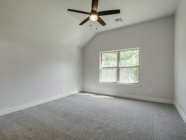 carpeted spare room featuring ceiling fan and lofted ceiling